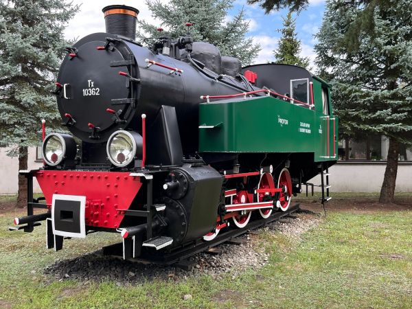 A vintage steam locomotive displayed outdoors.