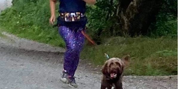 happy lady running a with her dog