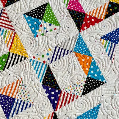 Bright colored geometric quilt showing the Ba Da Boom edge-to-edge design