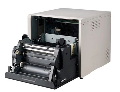 Open thermal label printer showing internal rollers and mechanisms.