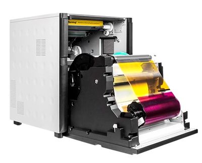 An open color label printer showing CMYK color ribbons inside.