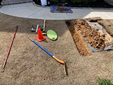 Subsurface sidewalk sleeve installation during a full system install in Apison, TN.