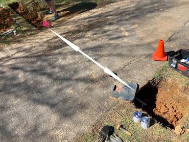 Sub-surface driveway sleeve installation in Hixson, TN.