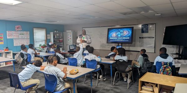 Teacher presenting to students in a classroom.