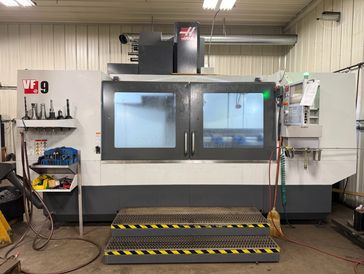 Large industrial CNC machine in workshop.
