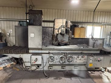 Industrial grinding machine in a workshop.