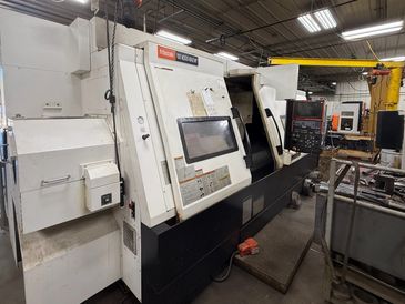 Industrial CNC lathe machine in a workshop.