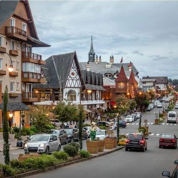 Charming street with European-style buildings and cars parked along the road.
