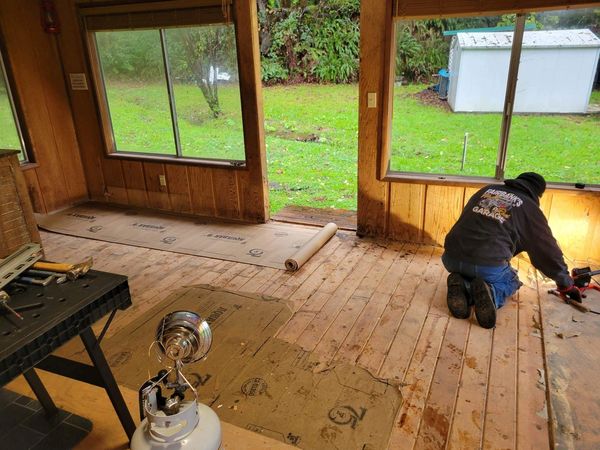 Before, with wood paneling and old flooring