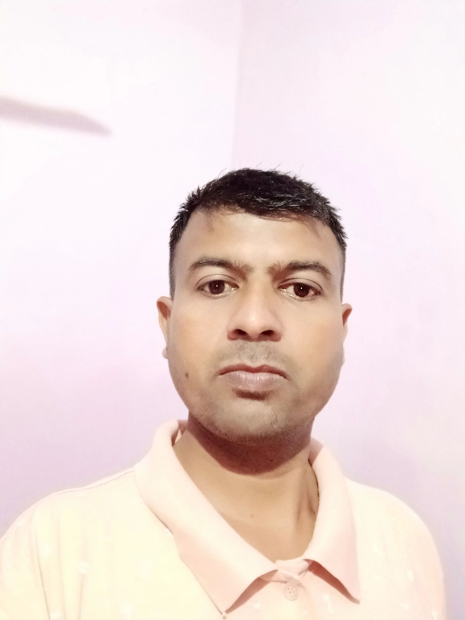 Nehemiah Dhariwal is in his room, wearing a T-shirt.