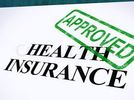 Document labeled Health Insurance with an Approved stamp.