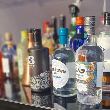A close up of a variety of different gins