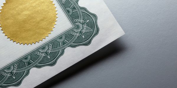 Close-up of a certificate with a gold seal.