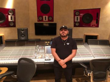 Man standing in a music recording studio.