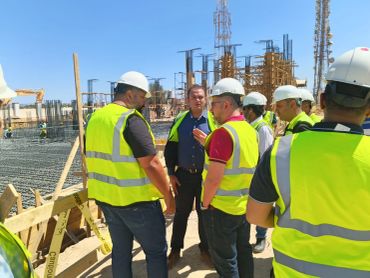 Group of construction workers discussing on site.