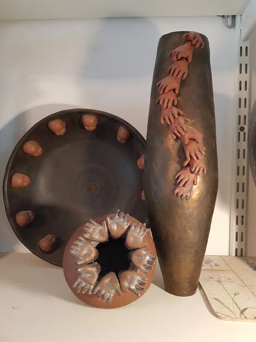 Group of ceramic pieces with mini hands used as decoration