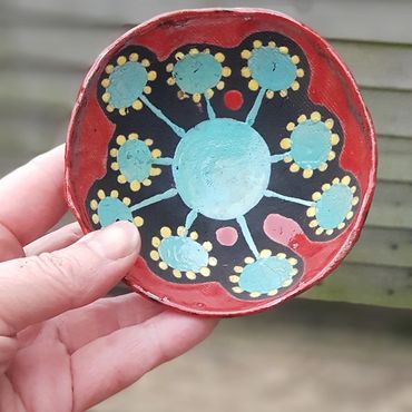 Raku fired dish with red and pale blue decoration