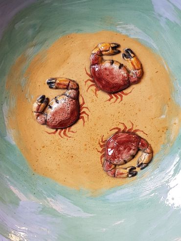 Three crabs on a sandy bottomed platter