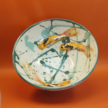 Three Koi swimming in a bowl