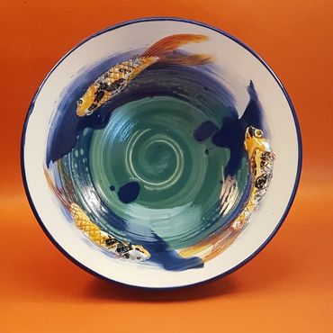 3 koi carp swimming in a bowl