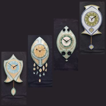 Four Wall Clocks decorated with coloured slips and scrafitto pattern