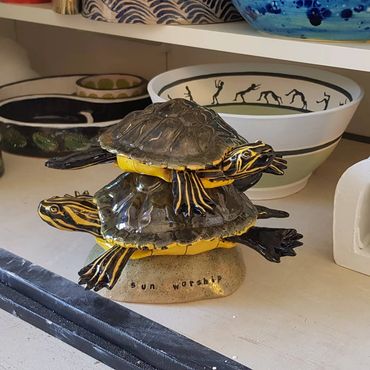 Two modelled yellow belly terrapins on top of each other