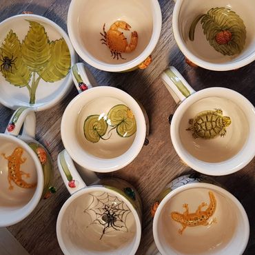 images on the bottom inside of cups of crab, newt and terrapin