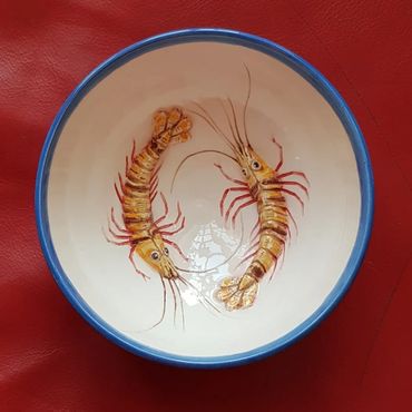 Two hand painted shrimp on a bowl