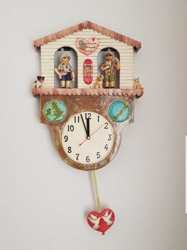 Cuckoo style clock with people and pets