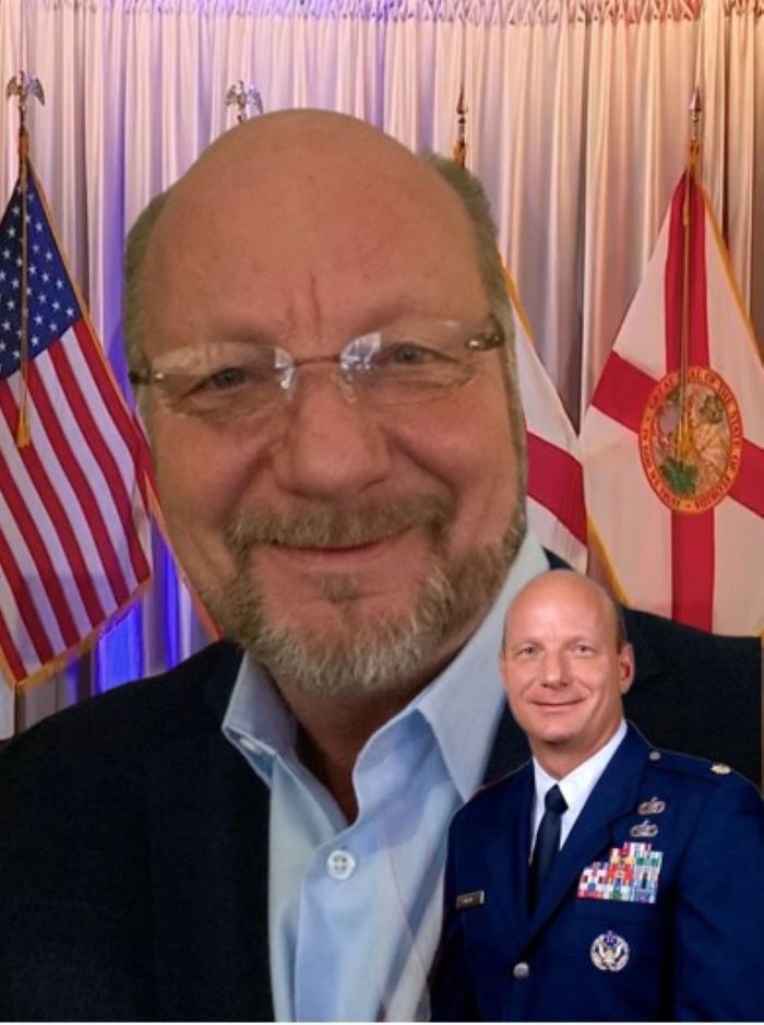 Military and businessmen smiling with American flags and a soldier in uniform.
