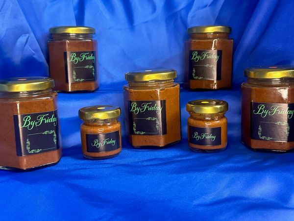 Seven jars of ByFriday sauce on blue cloth.