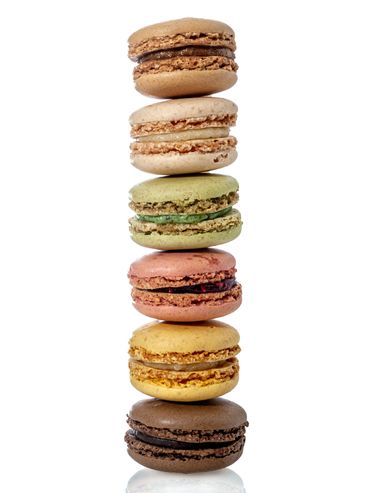 Stack of colorful macarons on white background