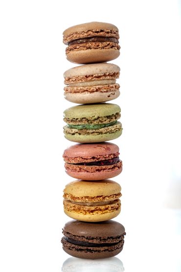 Stack of colorful macarons on white background, photographed with crisp studio lighting