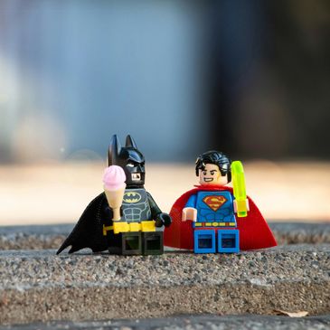 Lego Batman and Superman with ice cream and popsicle.
