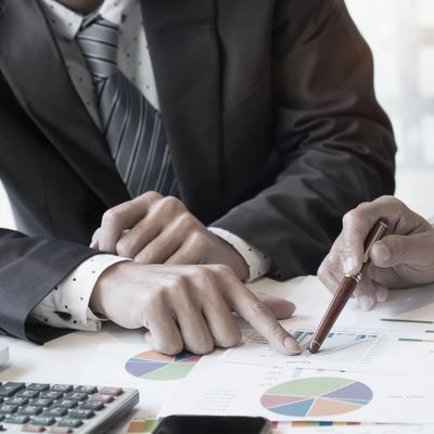 Business advisor analyzing financial figures denoting work progress, consult concept.