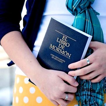 Mujer joven sosteniendo un ejemplar del Libro de Mormón.