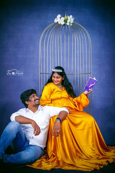Couple posing playfully with woman in yellow dress and crown.