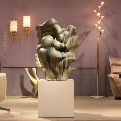 Abstract sculpture on a pedestal in a modern room.