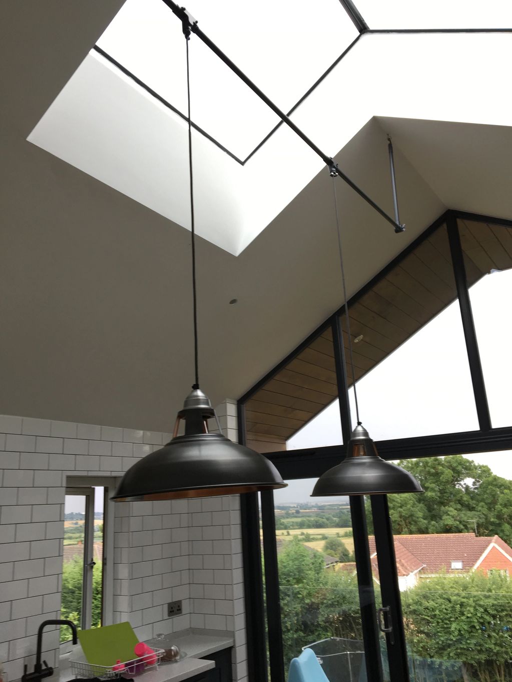Bespoke kitchen lighting made to fit above island and using matching colours.