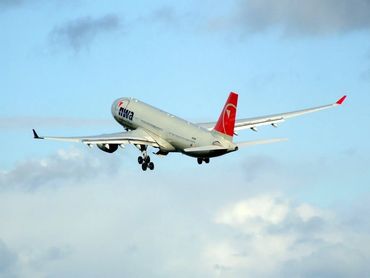 Northwest Airlines Airbus A330 climbing after takeoff, showcasing the carrier’s iconic red tail.