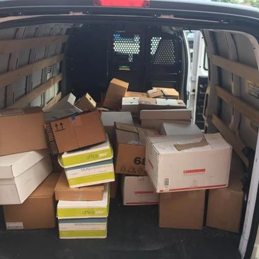 Van packed with various cardboard boxes.