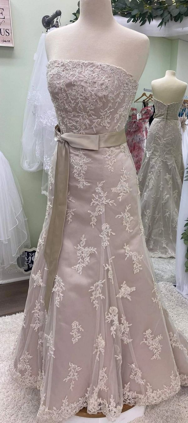 Elegant strapless gown with floral lace overlay and a satin waist bow.