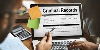 A picture of two people performing background checks on employees on a computer screen.