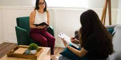 A person sitting on a couch doing a Behavioral Assessment of someone for a workplace hire.