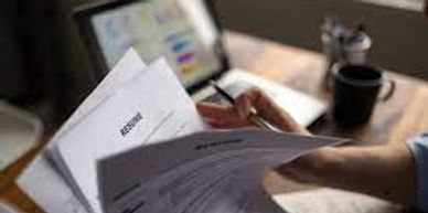 A picture of someone reviewing a high volume of applications for job interviews.