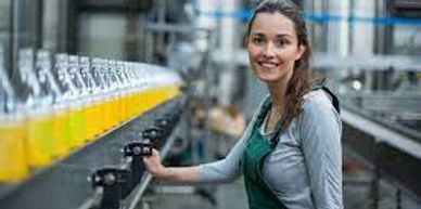 A woman standing on a production and manufacturing line.