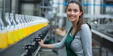 A woman standing on a production and manufacturing line.
