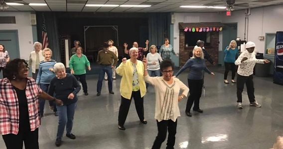 A group of our members enjoying a dance class together.