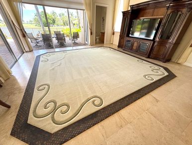 Spacious living room with beige rug and wooden entertainment center.