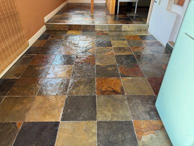 Glossy multi-colored slate tile floor with a step leading to a raised area.